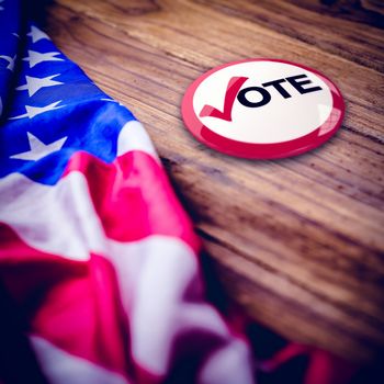 Political button against usa flag on table