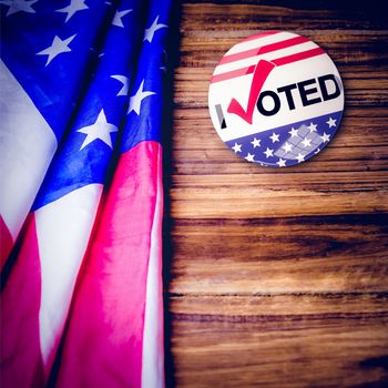 Political button against usa flag on table
