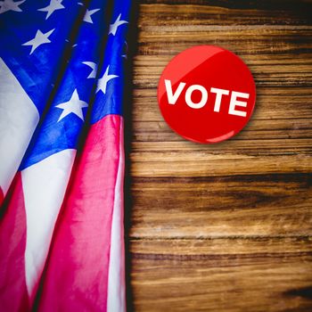 Political button against usa flag on table