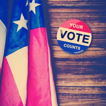 Political button against usa flag on table