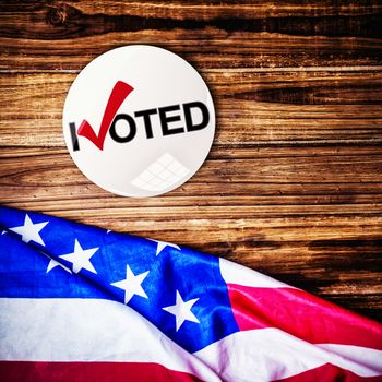 Political button against usa flag on table