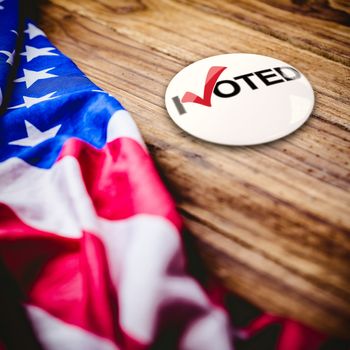 Political button against usa flag on table