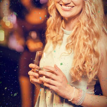 Portrait of cheerful blond woman against flying colours