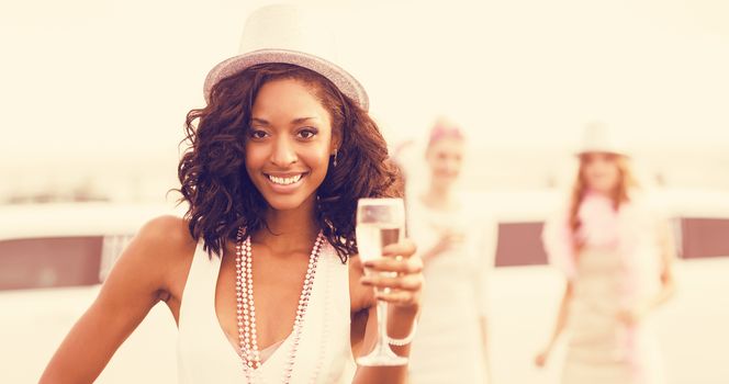 Portrait of friends holding champagne glasses while standing at outdoors