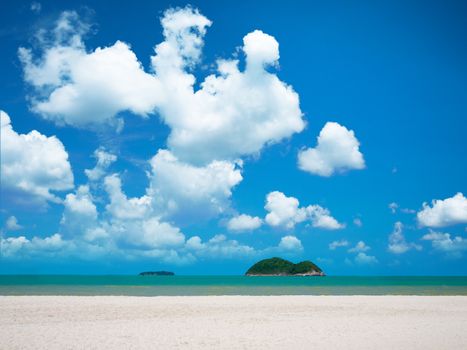 White sand beach with bright blue sky and cloud over sea with two island 
