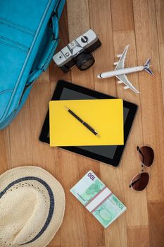 Various travel accessories on wooden floor