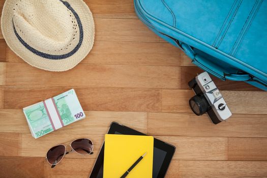 Various travel accessories on wooden floor