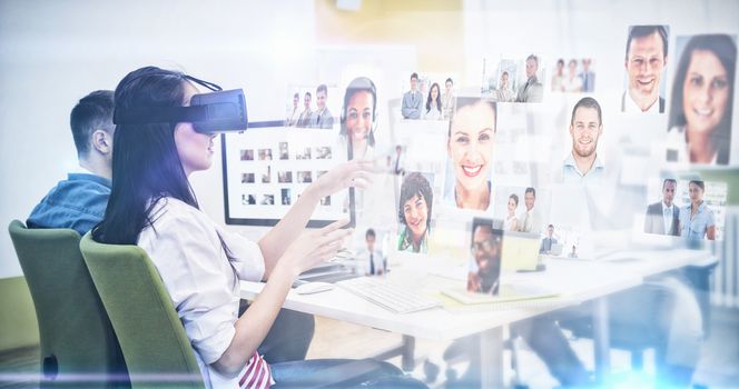 Business people against executive enjoying augmented reality headset with colleagues at creative office