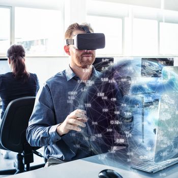 Earth globe against businessman wearing virtual reality simulator 