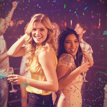 Happy friends dancing against flying colours