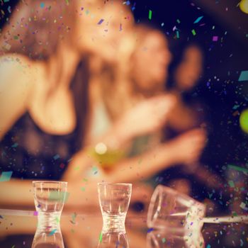 Three empty shooter glasses against flying colours