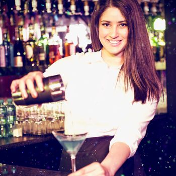 Portrait of bartender pouring blue martini drink in glass against flying colours