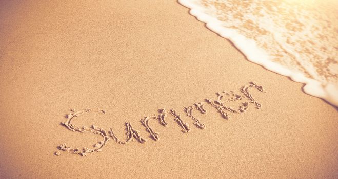 Summer written on sand with surf  at beach