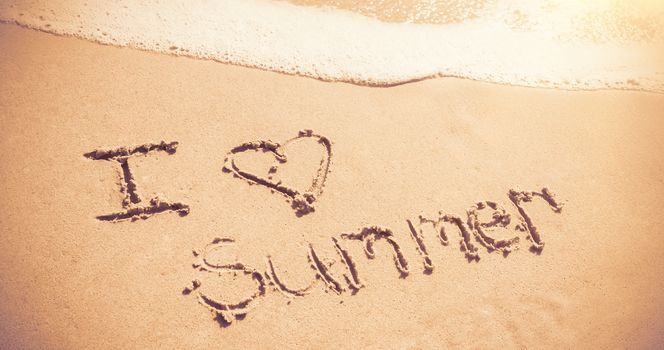 I love summer written on sand at beach