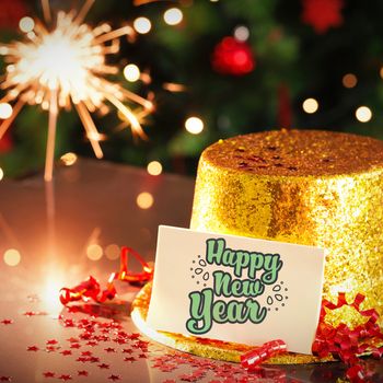  Digital composite of Happy new year card leaning on gold party hat