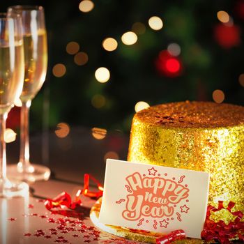  Digital composite of Happy new year card leaning on gold party hat