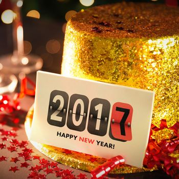  Digital composite of Happy new year card leaning on gold party hat