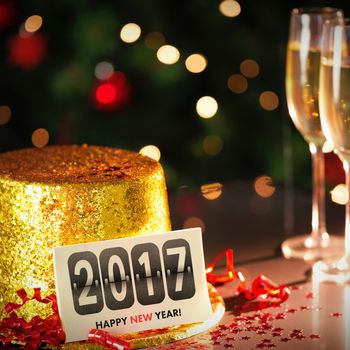  Digital composite of Happy new year card leaning on gold party hat