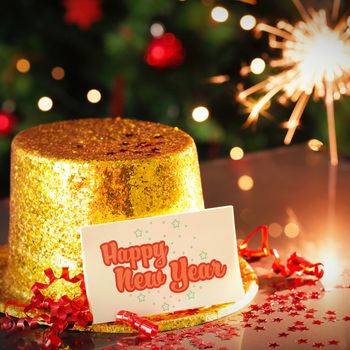 Digital composite of Happy new year card leaning on gold party hat