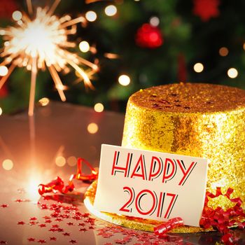  Digital composite of Happy new year card leaning on gold party hat