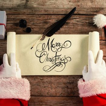 Close-up of santa claus opening scroll against merry christmas message