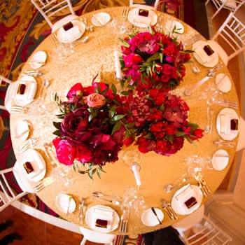 Beautiful bright bouquet of peony on the wedding table in vase.