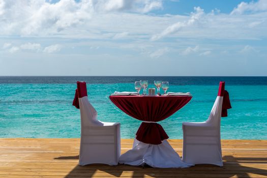 A festive table prepared for a couple on the beach by the sea