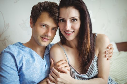 Portrait of romantic couple relaxing on bed in bedroom