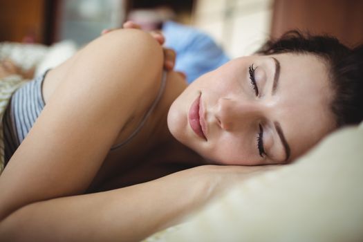 Romantic couple sleeping on bed in bedroom