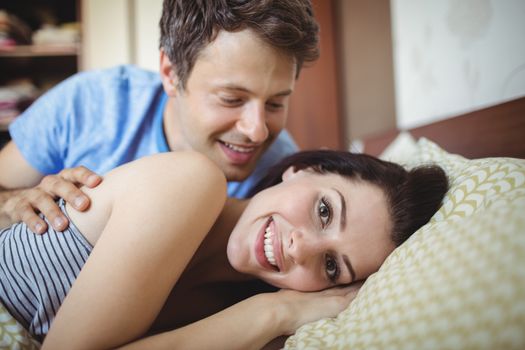 Romantic couple relaxing on bed in bedroom