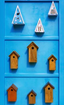Different types of birdhouses on the wall