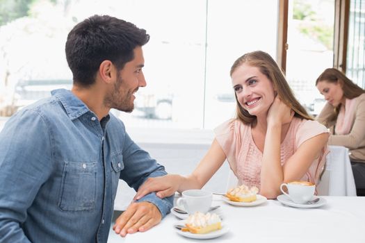 Romantic young couple sitting at the coffee shop