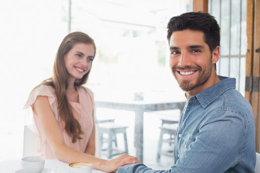 Romantic young couple sitting at the coffee shop