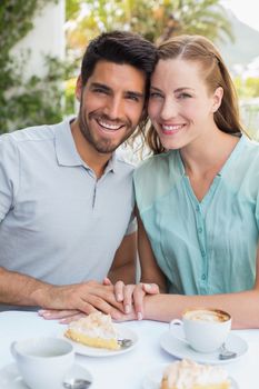 Portrait of a romantic young couple sitting at the coffee shop