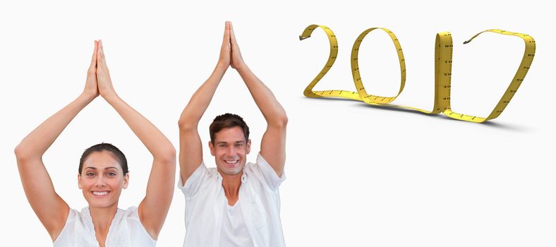 Peaceful couple in white doing yoga together with hands raised against white background with vignette 3D new year