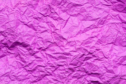 Pink crumpled paper background or texture in detail