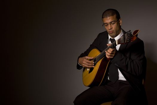 fado musician with a portuguese guitar, studio