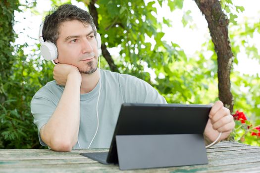 casual man working with a tablet pc, outdoor