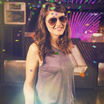 Young woman posing on dance floor against flying colours