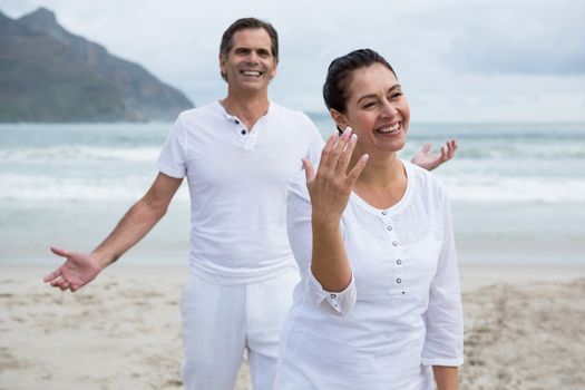 Romantic couple enjoying on beach during winter