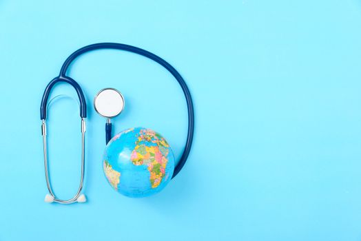 World health day concept, Stethoscope, globe on blue background with copy space. Global health care