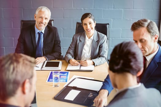 Business people interacting in conference room during meeting