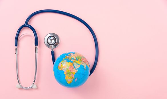 World health day concept, Stethoscope, globe on pink background with copy space. Global health care