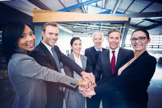 Businesspeople hands stacked over each other in office