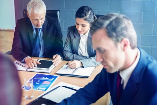 Business people interacting in conference room during meeting