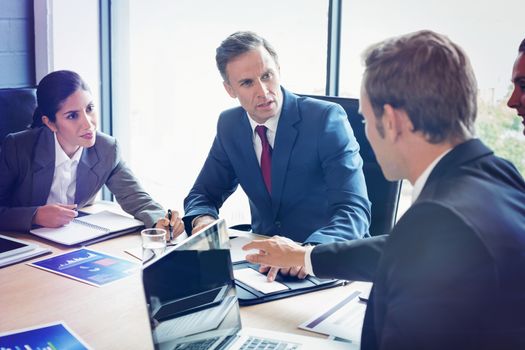 Business people interacting in conference room during meeting