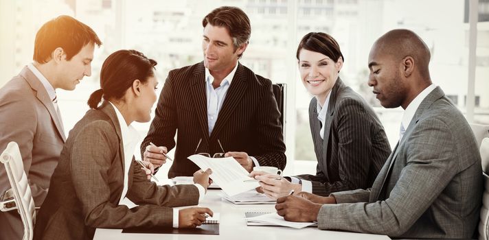 Business team showing ethnic diversity in a meeting smiling at the camera with copy spac