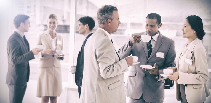 Business people chatting and drinking coffee at a conference in the office