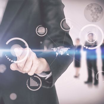 Businesswoman touching on digital screen with businesspeople standing in the background 3d