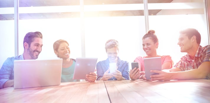 Young creative business people with laptop and digital tablet in the office